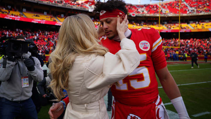 Kansas City Chiefs quarterback Patrick Mahomes (15) kisses his wife Brittany Mahomes before a 2025 AFC divisional round game against the Houston Texans at GEHA Field at Arrowhead Stadium.