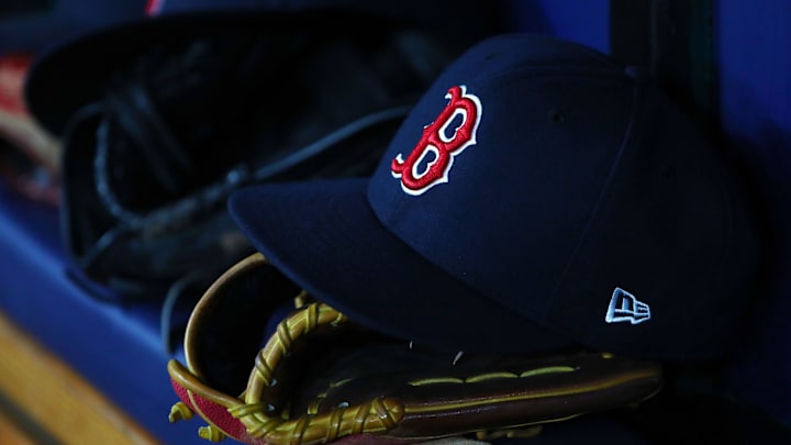 A detail view of Boston Red Sox hat and glove laying in the dugout at Tropicana Field in 2019.