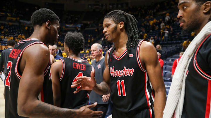 Houston teammates Terrance Arceneaux (left) and Joseph Tugler (11) following the Cougars' win at West Virginia on Jan. 29, 2025.