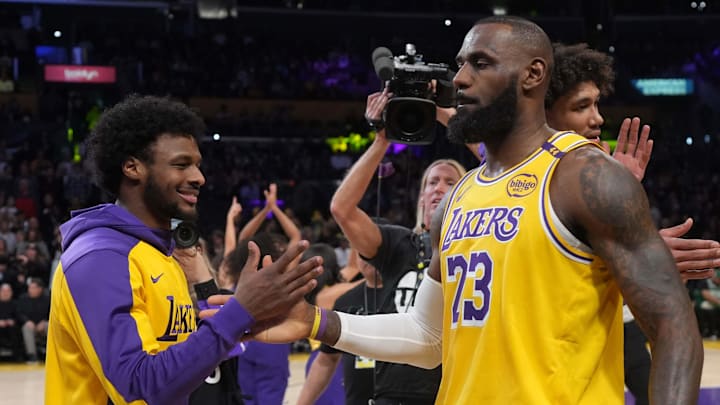 Jan 23, 2025; Los Angeles, California, USA; Los Angeles Lakers forward LeBron James (23) interacts with son Bronny James during the game against the Boston Celtics at the Crypto.com Arena. Mandatory Credit: Kirby Lee-Imagn Images
