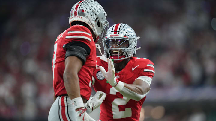 Dec 6, 2025; Indianapolis, IN, USA; Ohio State Buckeyes safety Caleb Downs (2) and cornerback Lorenzo Styles Jr. (3) react in the first half against the Indiana Hoosiers during the 2025 Big Ten championship game at Lucas Oil Stadium. Mandatory Credit: Aaron Doster-Imagn Images Dec 6, 2025; Indianapolis, IN, USA; Ohio State Buckeyes safety Caleb Downs (2) and cornerback Lorenzo Styles Jr. (3) react in the first half against the Indiana Hoosiers during the 2025 Big Ten championship game at Lucas Oil Stadium. Mandatory Credit: Aaron Doster-Imagn Images