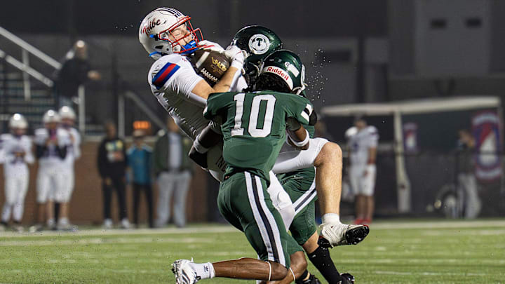 Madison Central's Christian Lawson (6) takes a hard hit from Trinity's Elijah Burns-Crump (10) and Myles Howze (4) as the Trinity Shamrocks and Madison Central Indians face off in the third round of the KHSAA Class 6A football playoffs. Trinity defeated Madison Central in a blowout, 64-27. Friday, Nov. 21, 2025. Madison Central's Christian Lawson (6) takes a hard hit from Trinity's Elijah Burns-Crump (10) and Myles Howze (4) as the Trinity Shamrocks and Madison Central Indians face off in the third round of the KHSAA Class 6A football playoffs. Trinity defeated Madison Central in a blowout, 64-27. Friday, Nov. 21, 2025.
