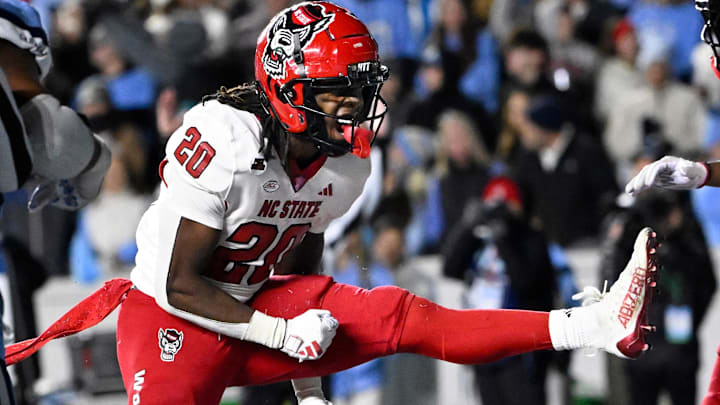 Nov 30, 2024; Chapel Hill, North Carolina, USA; North Carolina State Wolfpack running back Hollywood Smothers (20) reacts after scoring a touchdown with 25 seconds to go in the fourth quarter at Kenan Memorial Stadium. Mandatory Credit: Bob Donnan-Imagn Images