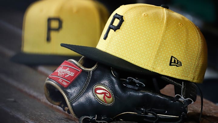 Sep 16, 2023; Pittsburgh, Pennsylvania, USA;  Pittsburgh Pirates hats and gloves in the dugout against the New York Yankees during the sixth inning at PNC Park.