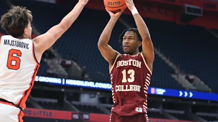 Feb 8, 2025; Syracuse, New York, USA; Boston College Eagles guard Donald Hand Jr. (13) takes a jump shot as Syracuse Orange forward Petar Majstorovic (6) defends in the first half at the JMA Wireless Dome. Mandatory Credit: Mark Konezny-Imagn Images