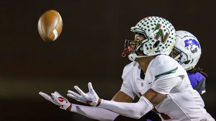 Lawrence North High School sophomore Monshun Sales (1) makes a reception for a 38-yard gain during the first half of an IHSAA Class 6A Regional Championship game against Brownsburg High School, Friday, Nov. 15, 2024, at Brownsburg High School.