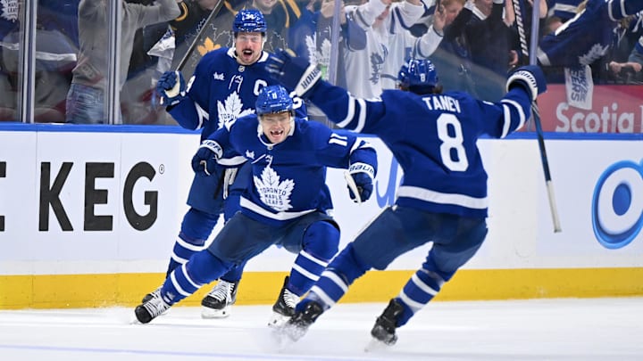 Apr 22, 2025; Toronto, Ontario, CAN;  Toronto Maple Leafs forward Max Domi (11) celebrates with defenseman Chris Tanev (8) and forward Auston Matthews (34) after scoring the winning goal in overtime against the Ottawa Senators in game two of the first round of the 2025 Stanley Cup Playoffs at Scotiabank Arena. Mandatory Credit: Dan Hamilton-Imagn Images