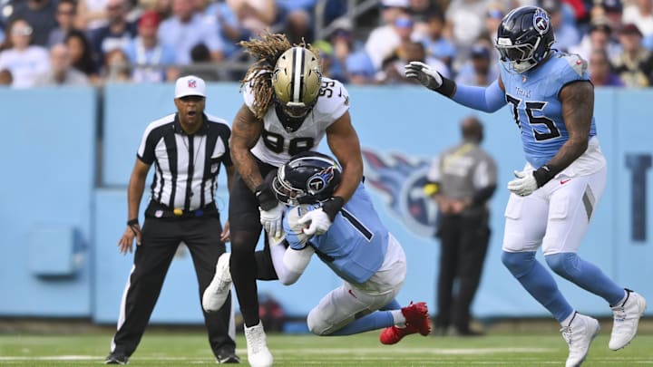 Dec 28, 2025; Nashville, Tennessee, USA; New Orleans Saints defensive end Chase Young (99) strips Tennessee Titans quarterback Cam Ward (1) during the first half of the game at Nissan Stadium. Mandatory Credit: Steve Roberts-Imagn Images Dec 28, 2025; Nashville, Tennessee, USA; New Orleans Saints defensive end Chase Young (99) strips Tennessee Titans quarterback Cam Ward (1) during the first half of the game at Nissan Stadium. Mandatory Credit: Steve Roberts-Imagn Images
