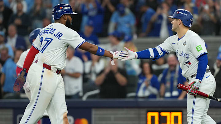 Oct 24, 2025; Toronto, Ontario, CAN; Toronto Blue Jays first baseman Vladimir Guerrero Jr. (27) celebrates with center fielder Daulton Varsho (5) after scoring in the sixth inning against the Los Angeles Dodgers during game one of the 2025 MLB World Series at Rogers Centre. Oct 24, 2025; Toronto, Ontario, CAN; Toronto Blue Jays first baseman Vladimir Guerrero Jr. (27) celebrates with center fielder Daulton Varsho (5) after scoring in the sixth inning against the Los Angeles Dodgers during game one of the 2025 MLB World Series at Rogers Centre.