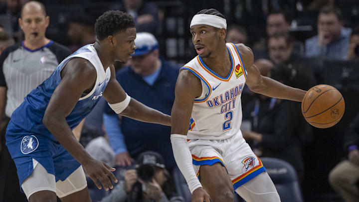 Jan 20, 2024; Minneapolis, Minnesota, USA; Oklahoma City Thunder guard Shai Gilgeous-Alexander (2) looks to pass the ball as Minnesota Timberwolves guard Anthony Edwards (5) plays defense in the second half at Target Center. Mandatory Credit: Jesse Johnson-Imagn Images