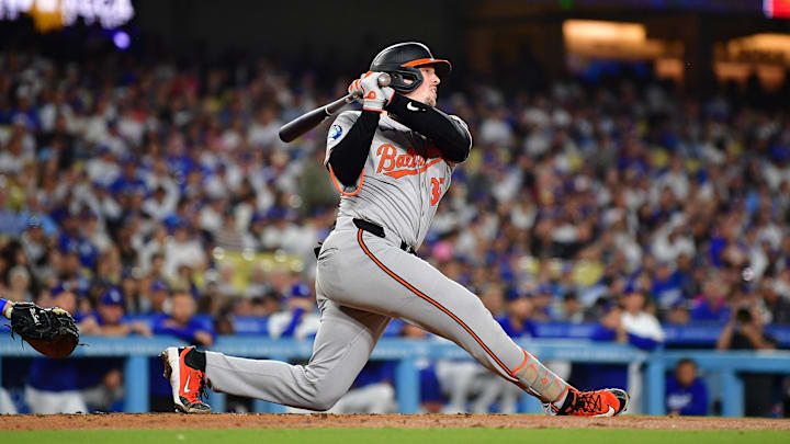 Los Angeles, California, USA; Baltimore Orioles catcher Adley Rutschman (35) hits a single against the Los Angeles Dodgers during the third inning at Dodger Stadium.