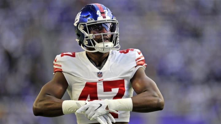 Linebacker Cam Brown looks on during warmups for the New York Giants before a wild card game against the Minnesota Vikings at U.S. Bank Stadium in the 2022 playoffs.