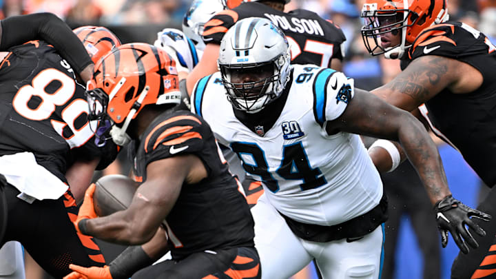 Sep 29, 2024; Charlotte, North Carolina, USA; Carolina Panthers defensive end A'Shawn Robinson (94) chases Cincinnati Bengals running back Zack Moss (31) in the fourth quarter at Bank of America Stadium. Mandatory Credit: Bob Donnan-Imagn Images