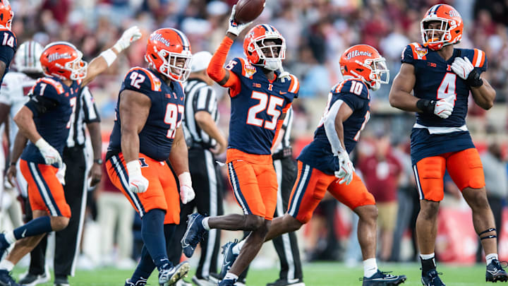 Dec 31, 2024; Orlando, FL, USA; Illinois Fighting Illini defensive back Jaheim Clarke (25) celebrates his fumble recovery against the South Carolina Gamecocks in the third quarter at Camping World Stadium. Mandatory Credit: Jeremy Reper-Imagn Images
