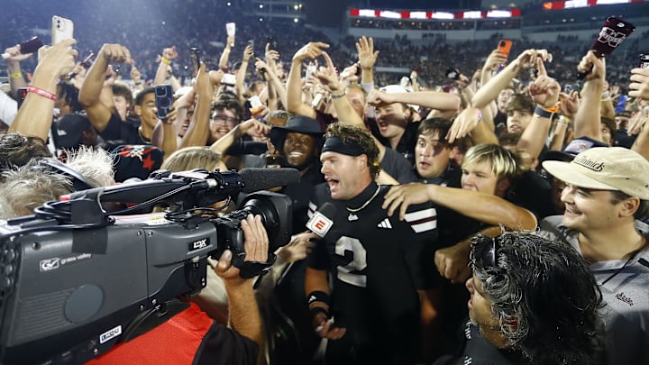 Sep 6, 2025; Starkville, Mississippi, USA; Mississippi State Bulldogs fans crowd around quarterback Blake Shapen (2) after defeating the Arizona State Sun Devilsat Davis Wade Stadium at Scott Field. Mandatory Credit: Petre Thomas-Imagn Images