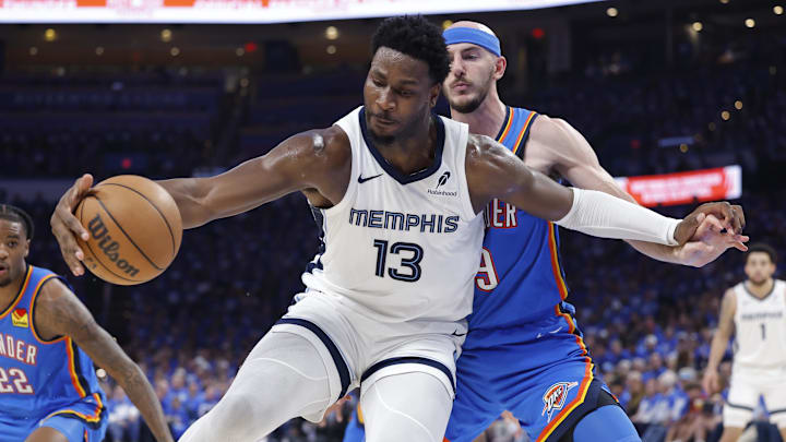 Apr 22, 2025; Oklahoma City, Oklahoma, USA; Memphis Grizzlies forward Jaren Jackson Jr. (13) moves the ball against Oklahoma City Thunder guard Alex Caruso (9) in the third quarter during game two of first round for the 2024 NBA Playoffs at Paycom Center. Mandatory Credit: Alonzo Adams-Imagn Images