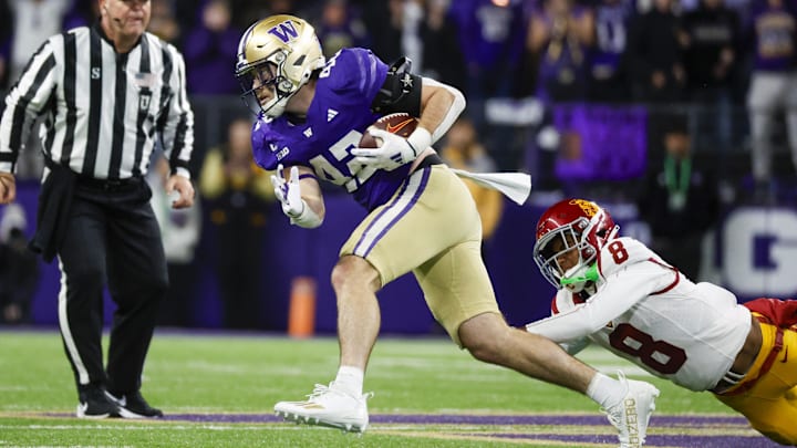 Huskies linebacker Carson Bruener returns an interception against USC, wide receiver JaKobi Lane trying to tackle him.