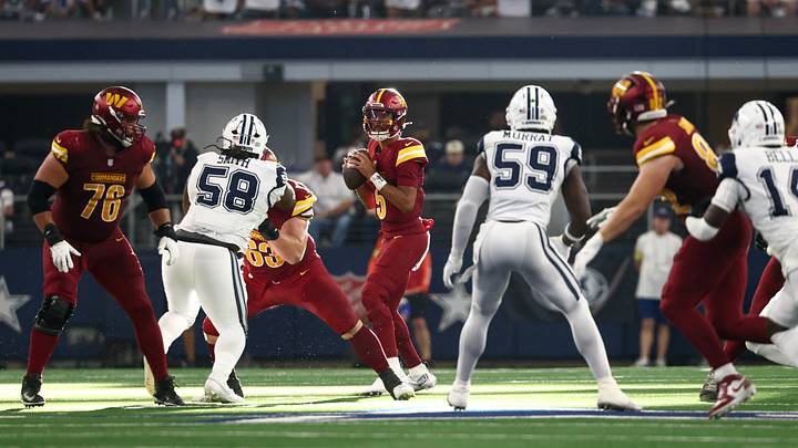 Oct 19, 2025; Arlington, Texas, USA; Washington Commanders quarterback Jayden Daniels (5) looks to pass the ball against the Dallas Cowboys during the fourth quarter of the game at AT&T Stadium. Mandatory Credit: Kevin Jairaj-Imagn Images