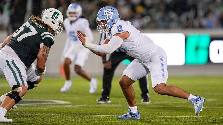 Sep 6, 2025; Charlotte, North Carolina, USA; North Carolina Tar Heels defensive lineman Melkart Abou-Jaoude (9) rushes against Charlotte 49ers offensive lineman Mason Bowers (57) during the first quarter at Jerry Richardson Stadium. Mandatory Credit: Jim Dedmon-Imagn Images
