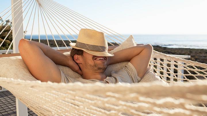 Man laying in a hammock on vacation