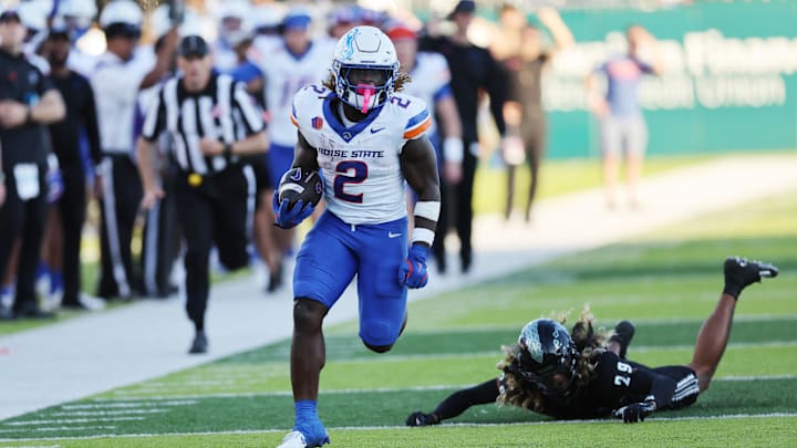 Oct 12, 2024; Honolulu, Hawaii, USA; Boise State Broncos running back Ashton Jeanty (2) gets past Hawaii Rainbow Warriors defensive back Kilinahe Mendiola-Jensen (29) for a touchdown during the first quarter at Clarence T.C. Ching Athletics Complex. Mandatory Credit: Marco Garcia-Imagn Images Oct 12, 2024; Honolulu, Hawaii, USA; Boise State Broncos running back Ashton Jeanty (2) gets past Hawaii Rainbow Warriors defensive back Kilinahe Mendiola-Jensen (29) for a touchdown during the first quarter at Clarence T.C. Ching Athletics Complex. Mandatory Credit: Marco Garcia-Imagn Images