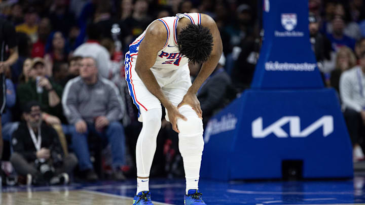 Feb 22, 2025; Philadelphia, Pennsylvania, USA; Philadelphia 76ers center Joel Embiid (21) holds his leg after a play against the Brooklyn Nets during the second quarter at Wells Fargo Center. Mandatory Credit: Bill Streicher-Imagn Images