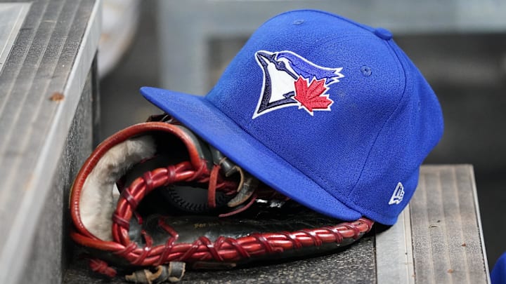 Apr 16, 2025; Toronto, Ontario, CAN; A Toronto Blue Jays hat and glove in the dugout during a game against the Atlanta Braves at Rogers Centre. 