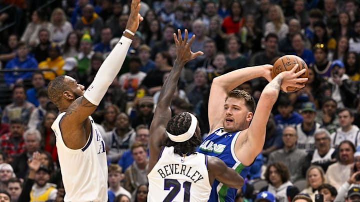 Dec 25, 2022; Dallas, Texas, USA; Dallas Mavericks guard Luka Doncic (77) looks to pass the ball around Los Angeles Lakers forward LeBron James (6) and guard Patrick Beverley (21) during the first quarter at the American Airlines Center. Mandatory Credit: Jerome Miron-Imagn Images