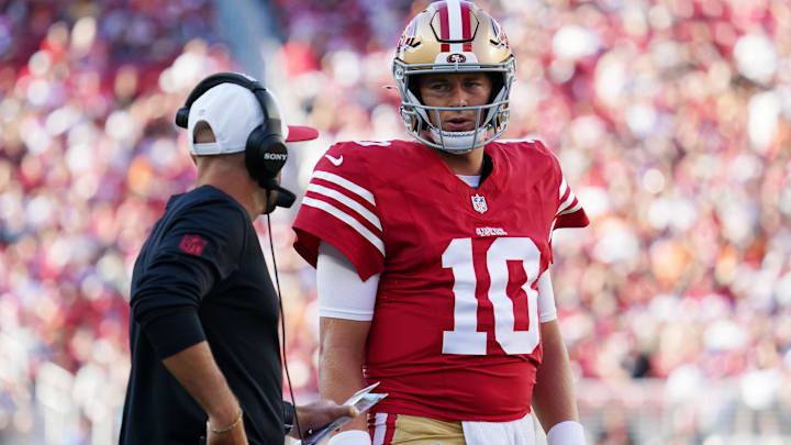 San Francisco 49ers quarterback Mac Jones (10) talks with quarterbacks coach Mick Lombardi in the first quarter against the Denver Broncos at Levi's Stadium.