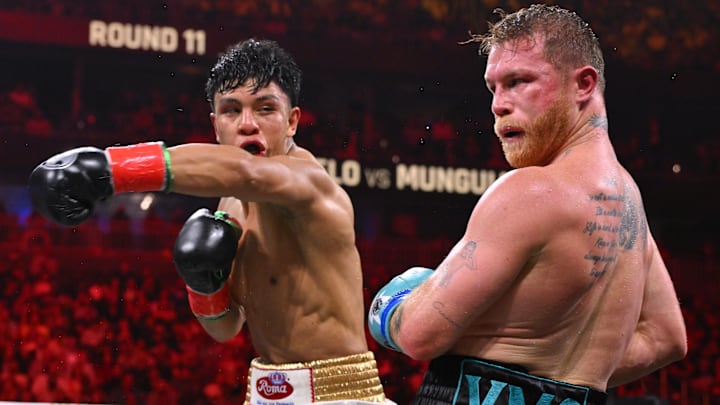 Jaime Munguia throws a left hook vs Saul "Canelo" Alvarez. Jaime Munguia throws a left hook vs Saul "Canelo" Alvarez.