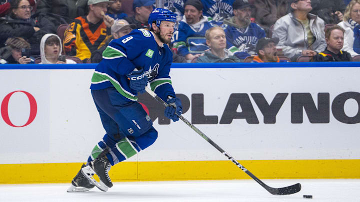 Jan 3, 2025; Vancouver, British Columbia, CAN; Vancouver Canucks forward J.T. Miller (9) handles the puck against the Nashville Predators in the third period at Rogers Arena. Mandatory Credit: Bob Frid-Imagn Images