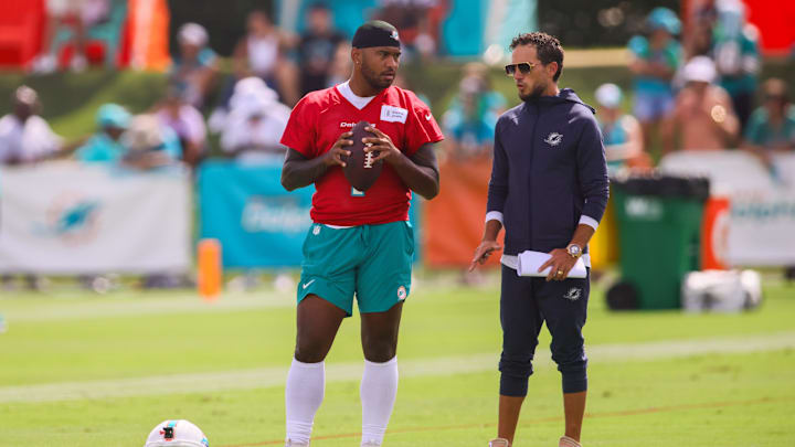 Miami Dolphins quarterback Tua Tagovailoa (1) talks to head coach Mike McDaniel during training camp at Baptist Health Training Complex.