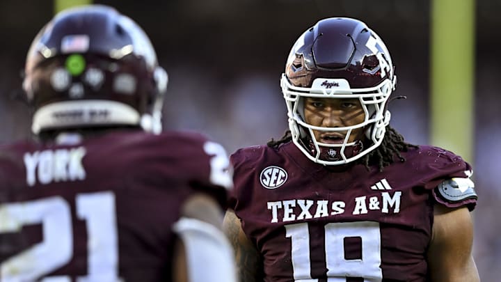 Texas A&M Aggies defensive end T.J. Searcy congratulates linebacker Taurean York after a sack in the second half against the Auburn Tigers at Kyle Field.