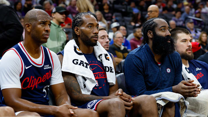 Oct 15, 2025; Sacramento, California, USA; Los Angeles Clippers guard Chris Paul (3) and forward Kawhi Leonard (2) and guard James Harden (1) sit on the bench during the fourth quarter against the Sacramento Kings at Golden 1 Center. Mandatory Credit: Sergio Estrada-Imagn Images