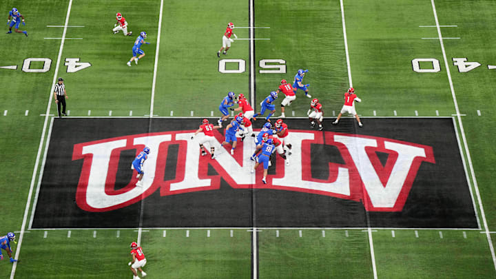 A general overall view as UNLV Rebels quarterback Jayden Maiava (1) throws the ball on the UNLV logo at midfield against the Boise State Broncos in the first half during the Mountain West Championship at Allegiant Stadium. Mandatory Credit: Kirby Lee-Imagn Images