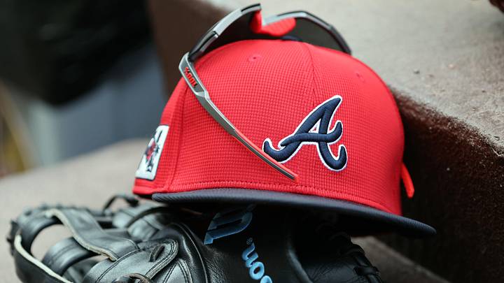 wMar 1, 2025; North Port, Florida, USA; A detail view of Atlanta Braves hat, sunglasses and glove in the dugout during the fifth inning at CoolToday Park. Mandatory Credit: Kim Klement Neitzel-Imagn Images
