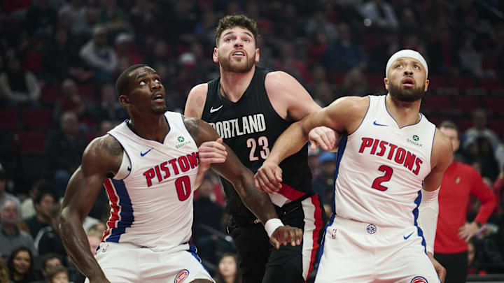 Dec 22, 2025; Portland, Oregon, USA; Detroit Pistons center Jalen Duren (0) and guard Cade Cunningham (2) vie for position on a free throw shot against Portland Trail Blazers center Donovan Clingan (23) during the first half at Moda Center. Mandatory Credit: Troy Wayrynen-Imagn Images