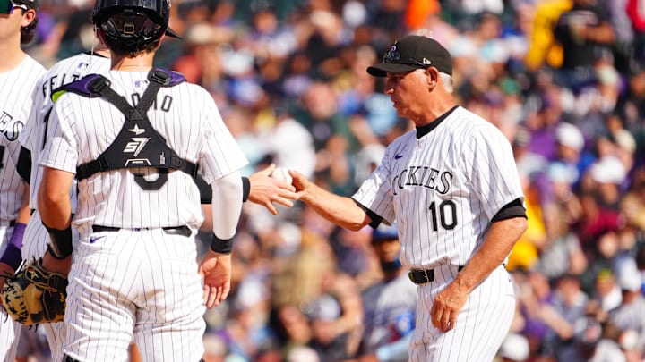 Sep 29, 2024; Denver, Colorado, USA; Colorado Rockies manager Bud Black (10) pulls starting pitcher Ryan Feltner (18) in front of catcher Drew Romo (3) delivers a pitch in the sixth inning against the Los Angeles Dodgers at Coors Field.