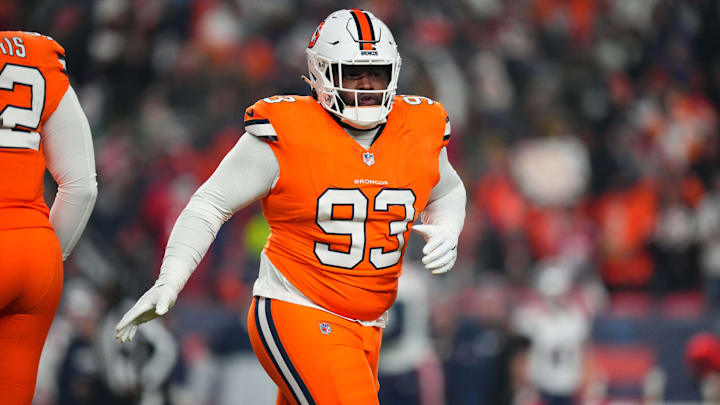 Dec 24, 2023; Denver, Colorado, USA; Denver Broncos defensive tackle D.J. Jones (93) following his sack fumble recovery in the first quarter against the New England Patriots at Empower Field at Mile High. Mandatory Credit: Ron Chenoy-Imagn Images