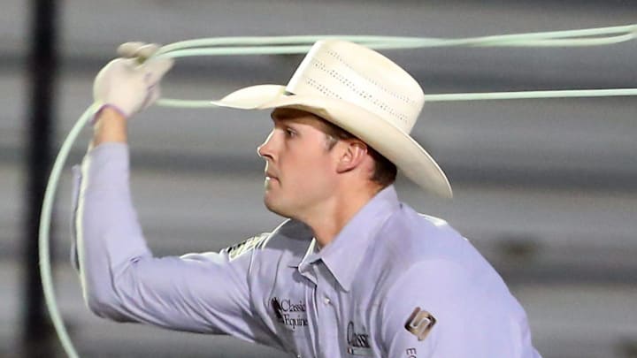Team roper Wyatt Dalton Bray, of Stephenville, Texas, takes aim at with his rope as he exits the chutes for opening night of the Kitsap Fair & Stampede rodeo on Wednesday, Aug. 23, 2023.