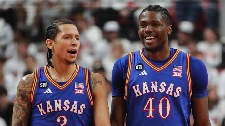 Feb 2, 2026; Lubbock, Texas, USA;  Kansas Jayhawks guard Tre White (3) and Kansas Jayhawks forward Flory Bidunga (40) visit during a time out in the second half of the game against the Texas Tech Red Raiders at United Supermarkets Arena. Mandatory Credit: Michael C. Johnson-Imagn Images