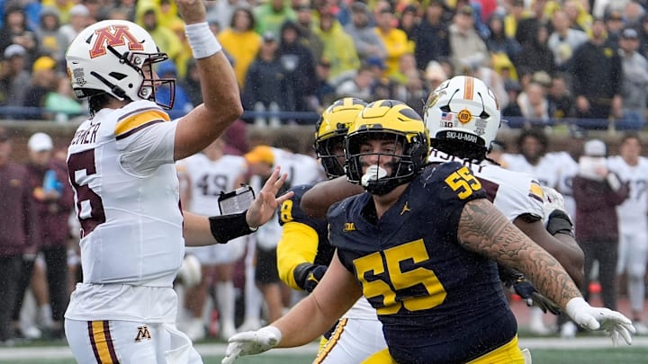 Minnesota quarterback Max Brosmer throws quickly as Michigan defensive lineman Mason Graham comes after him during first-half action between Michigan and Minnesota at Michigan Stadium in Ann Arbor on Saturday, Sept. 28, 2024.