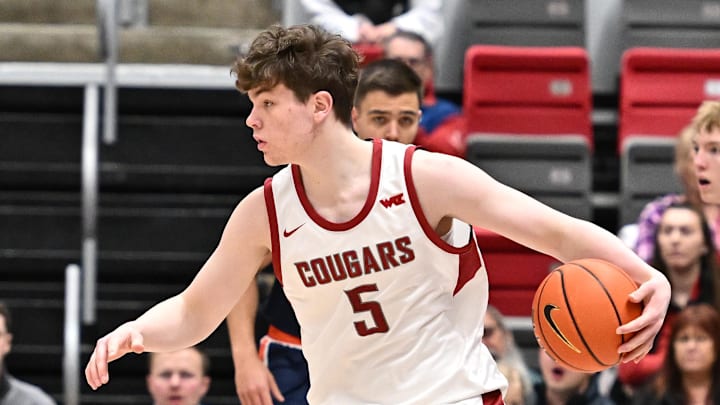 Feb 8, 2025; Pullman, Washington, USA; Washington State Cougars guard Tomas Thrastarson (5) controls the ball against the Pepperdine Waves in the first half at Friel Court at Beasley Coliseum. Mandatory Credit: James Snook-Imagn Images