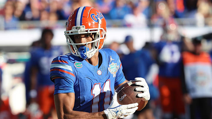 Dec 20, 2024; Tampa, FL, USA; Florida Gators wide receiver Aidan Mizell (11) runs with the ball against the Tulane Green Wave during the first quarter at Raymond James Stadium. Mandatory Credit: Kim Klement Neitzel-Imagn Images