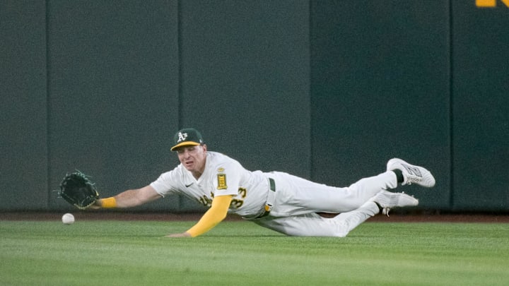 May 9, 2025; West Sacramento, California, USA; Athletics outfielder JJ Bleday (33) attempts a diving catch against the New York Yankees during the fifth inning at Sutter Health Park. Mandatory Credit: Ed Szczepanski-Imagn Images