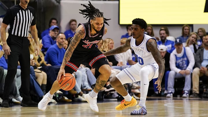 Feb 7, 2026; Provo, Utah, USA; Houston Cougars guard Emanuel Sharp (21) controls the ball while being defended by during the first half at Marriott Center. 