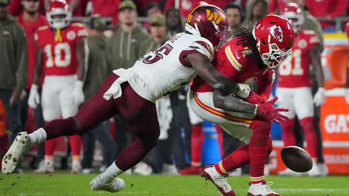 Oct 27, 2025; Kansas City, Missouri, USA; Kansas City Chiefs wide receiver Rashee Rice (4) fumbles the ball defended by Washington Commanders safety Darnell Savage (25)