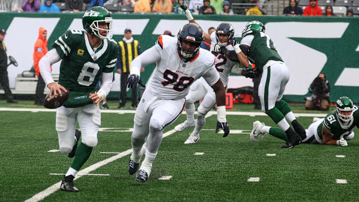 Sep 29, 2024; East Rutherford, New Jersey, USA; New York Jets quarterback Aaron Rodgers (8) scrambles as Denver Broncos defensive end John Franklin-Myers (98) pursues during the first half at MetLife Stadium. Mandatory Credit: Vincent Carchietta-Imagn Images
