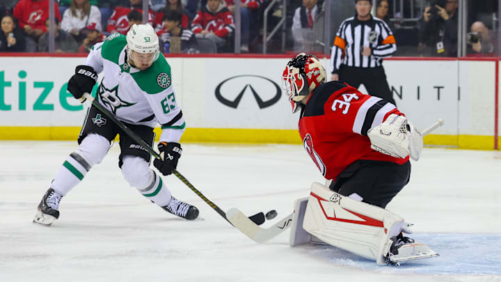 New Jersey Devils goaltender Jake Allen (34) makes a save on Dallas Stars right wing Evgenii Dadonov (63). Mandatory Credit: Ed Mulholland-Imagn Images