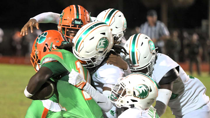 Multiple Atlantic defenders swarm the ball-carrier during the Eagles' district win over Blanche Ely on Sept. 13, 2024.